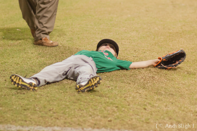 Nathan laying down in the outfield